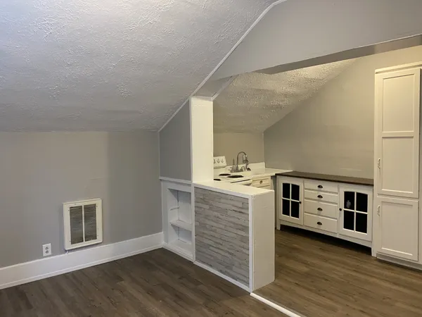 a room with a wooden floor and a table