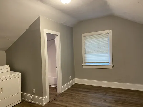a white toilet sitting next to a bath tub