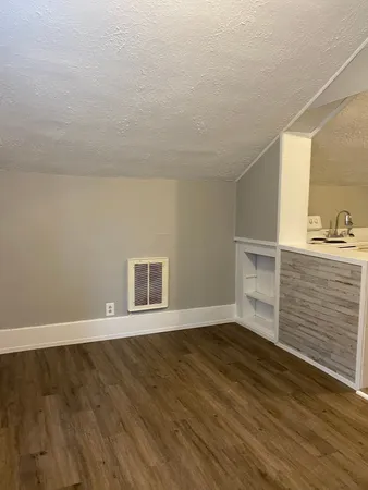 a view of entryway with wooden floor and fence