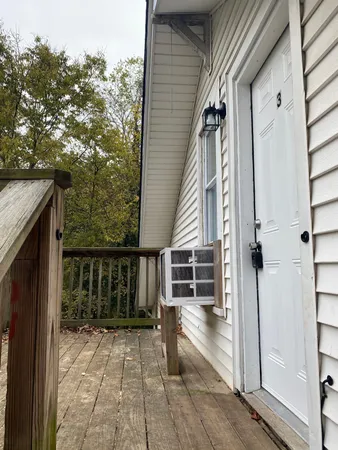 a front view of house with yard and trees in the background