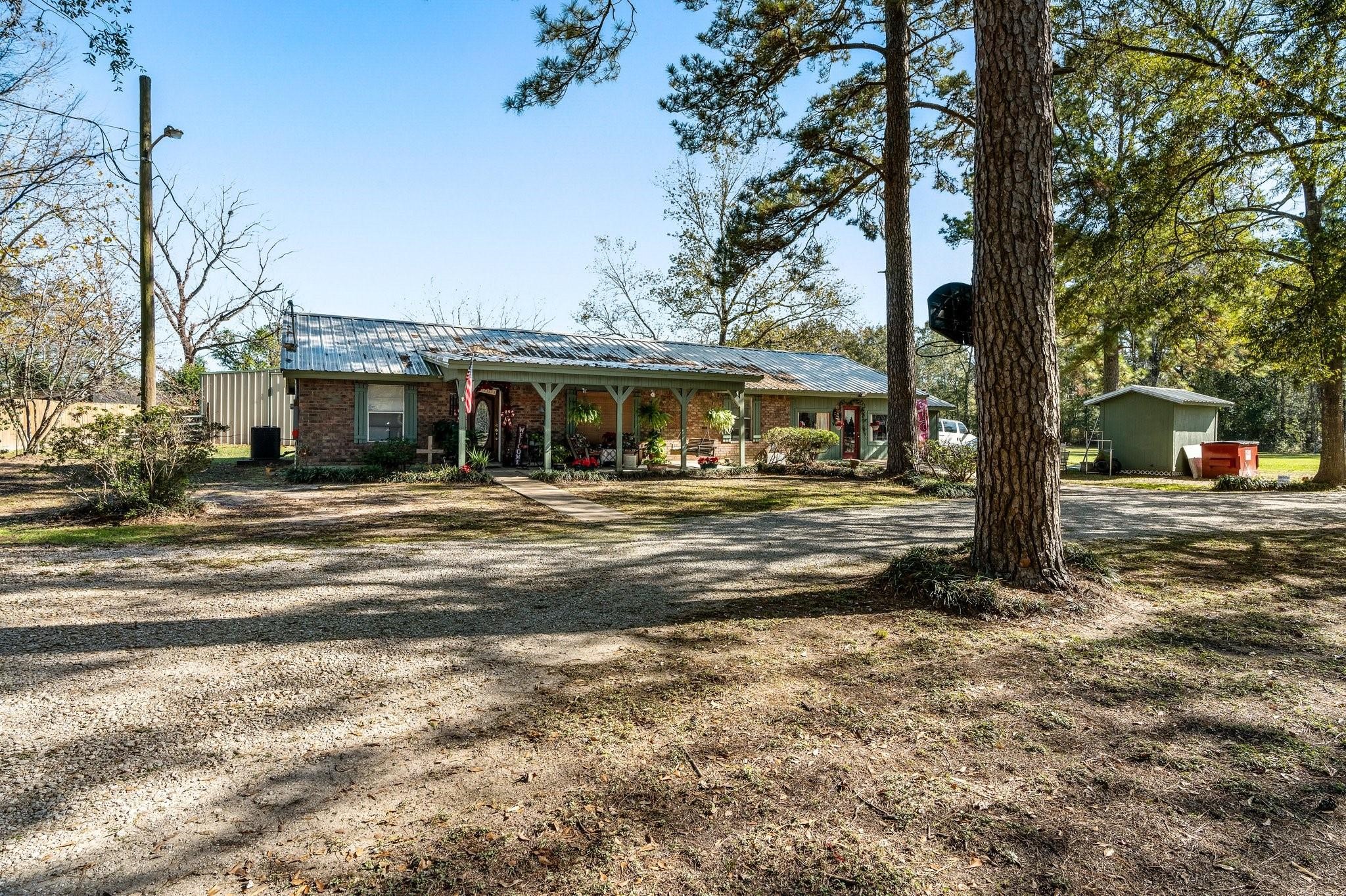 15091 Farm To Market 1485 Conroe, TX 77306 - Photo 4 of 28 a view of a house with a large tree
