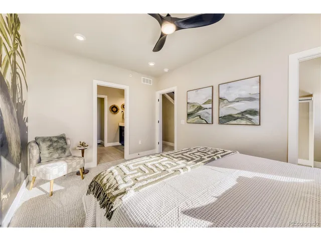a bedroom with a large bed and a chandelier