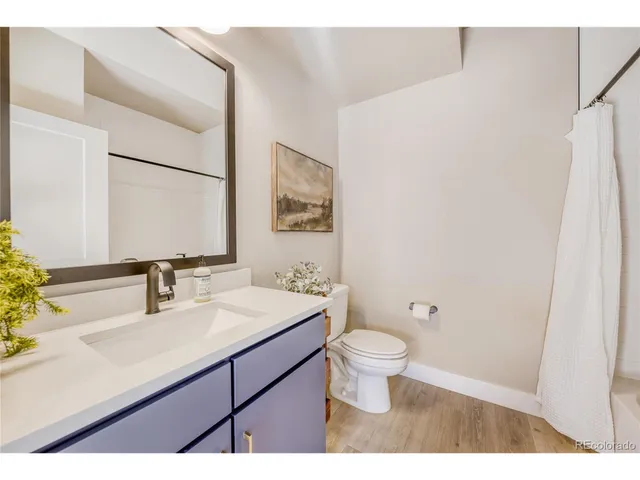 a bathroom with a sink toilet a mirror and vanity