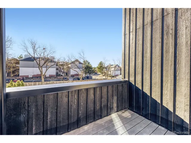 a view of a balcony with wooden floor