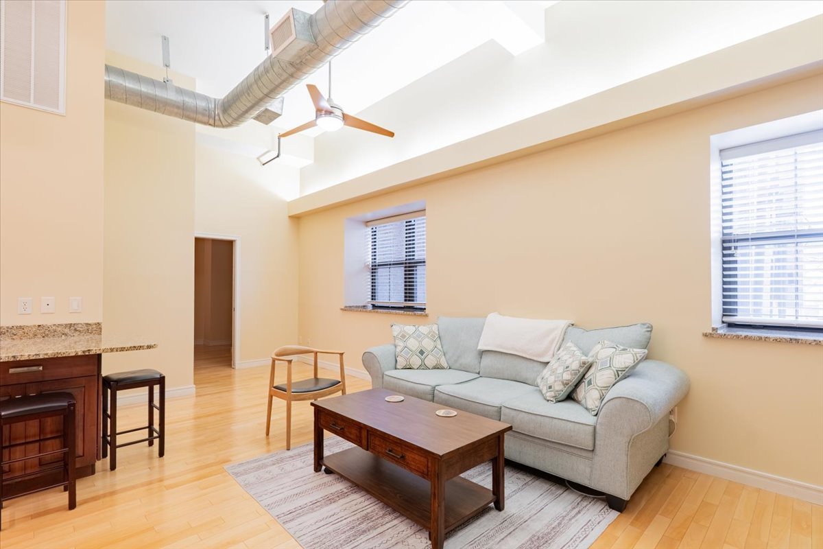 a living room with furniture and wooden floor