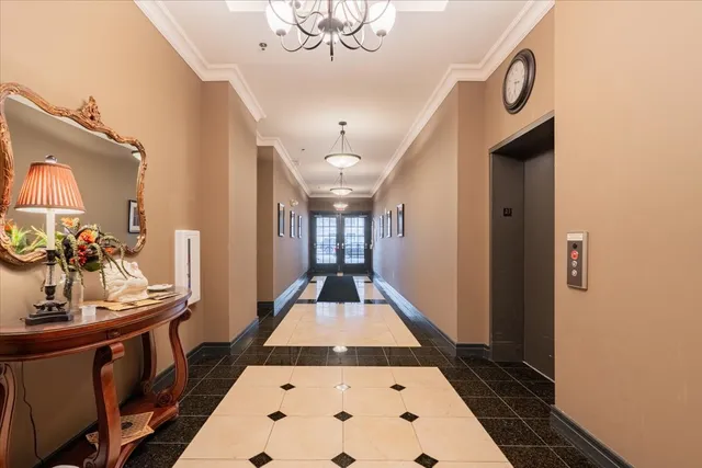 a view of a hallway to a livingroom with furniture