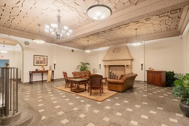 a living room with furniture and a chandelier