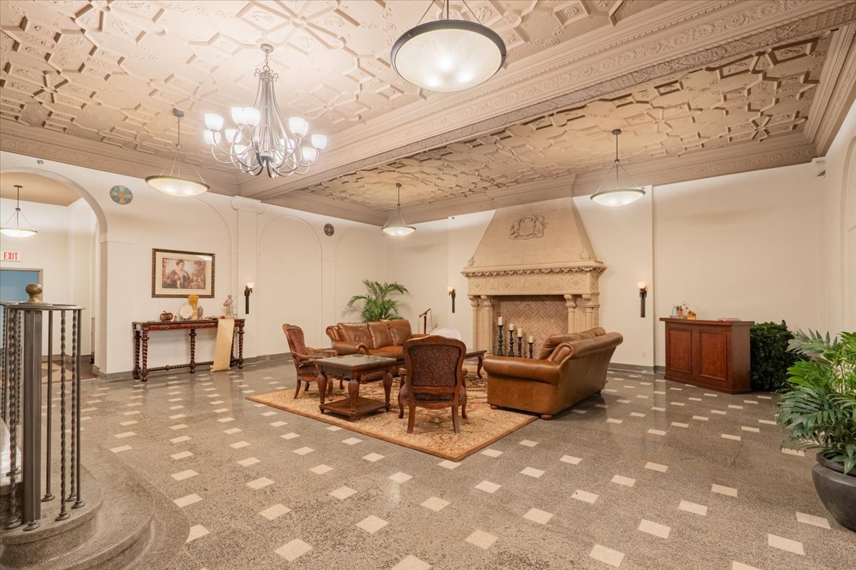 212 North Center Street, Unit 104 Bloomington, IL 61701 - Photo 15 of 22 a living room with furniture and a chandelier