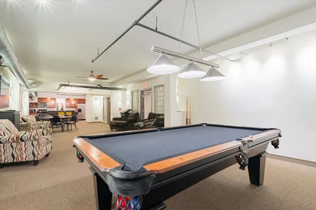 a room with furniture pool table and flat screen tv