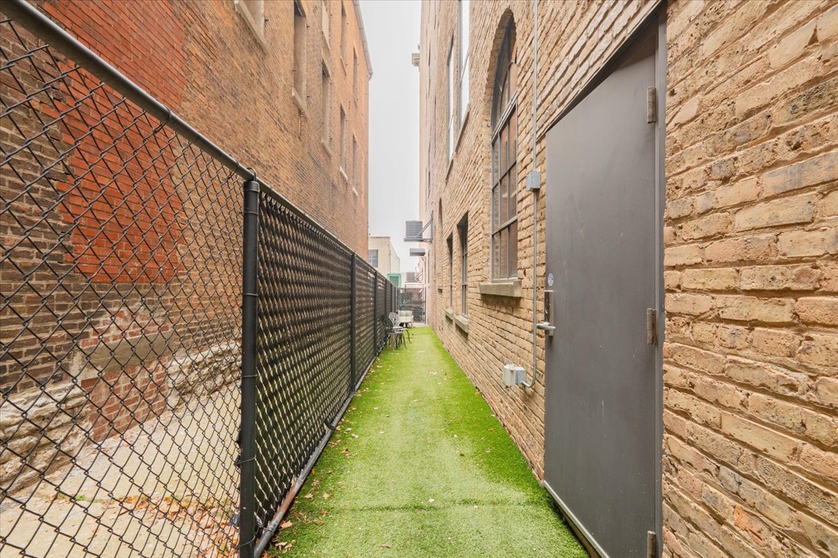 212 North Center Street, Unit 104 Bloomington, IL 61701 - Photo 22 of 22 a view of a pathway of a building from a balcony