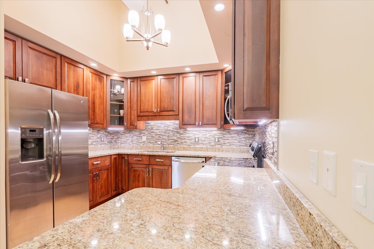 212 North Center Street, Unit 104 Bloomington, IL 61701 - Photo 4 of 22 a kitchen with granite countertop a sink stove and refrigerator