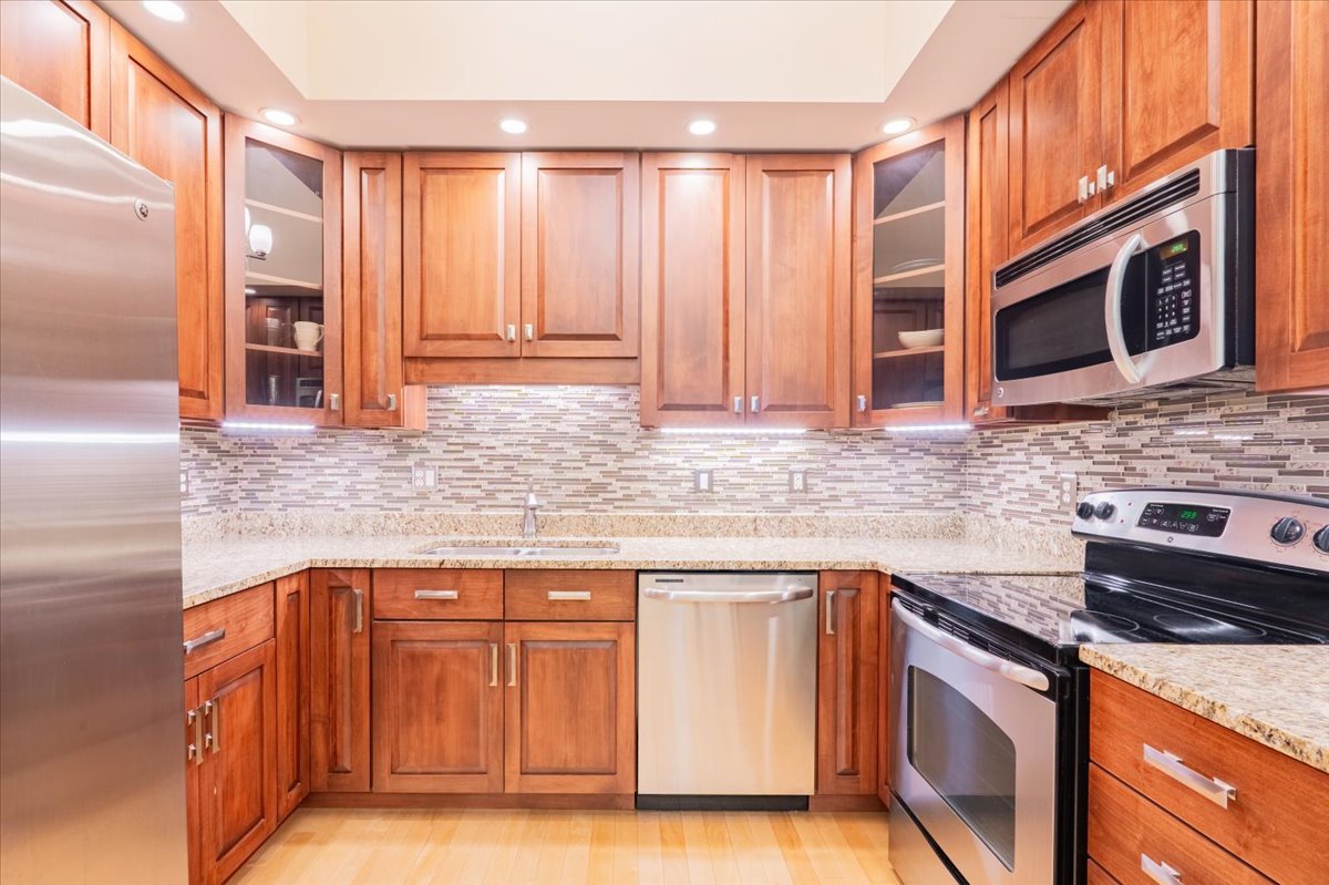 212 North Center Street, Unit 104 Bloomington, IL 61701 - Photo 5 of 22 a kitchen with stainless steel appliances granite countertop cabinets and a counter top space