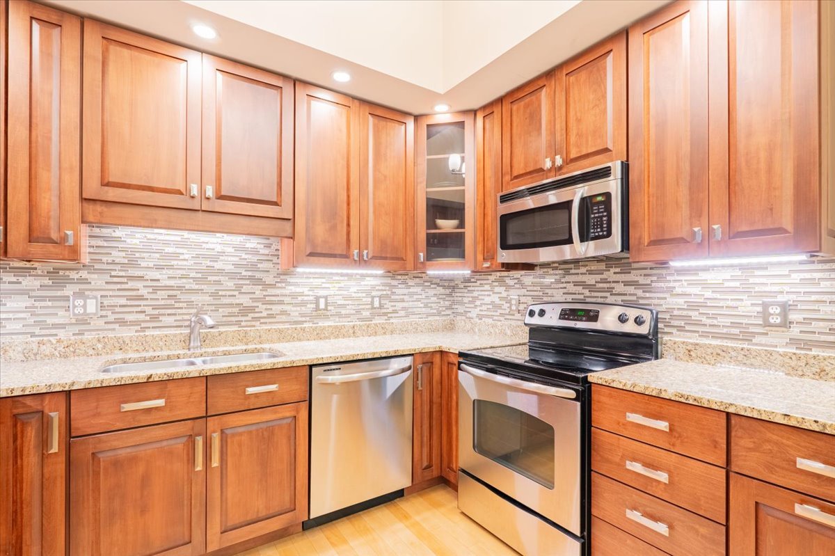 212 North Center Street, Unit 104 Bloomington, IL 61701 - Photo 6 of 22 a kitchen with granite countertop cabinets stainless steel appliances and a sink