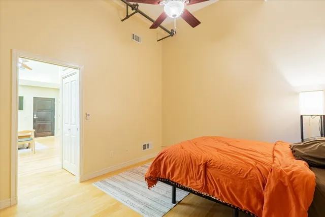 a bedroom with a bed and wooden floor