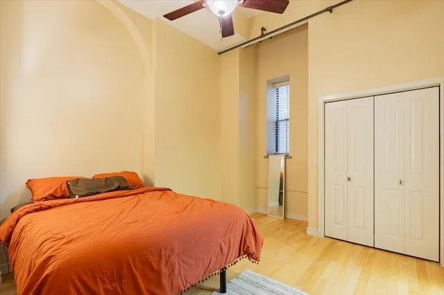 a bedroom with a bed and wooden floor