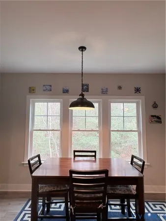 a dining room with a window and furniture