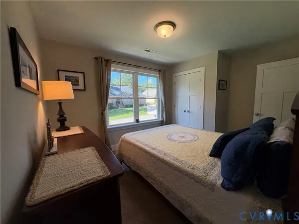a bedroom with a bed and a lamp on table