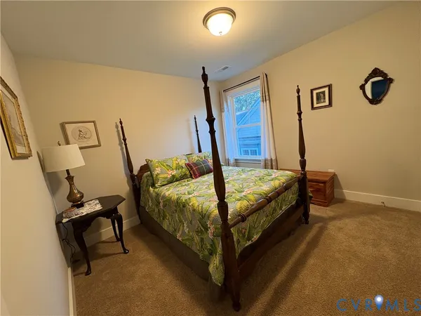 a bed sitting in a room next to a window