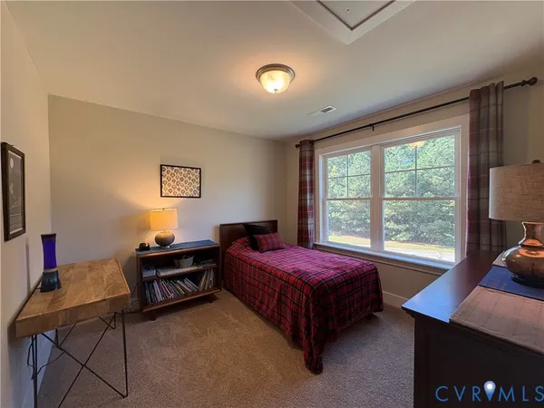 a bedroom with a bed and a desk