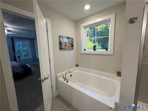 a white bath tub sitting next to a window