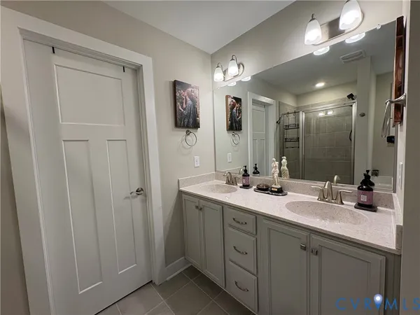 a bathroom with a double vanity sink and a mirror