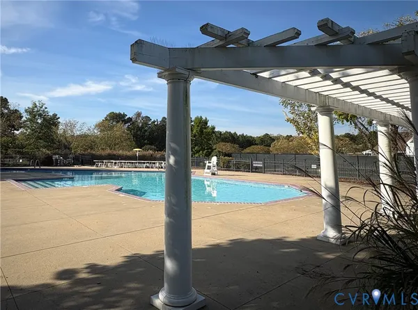 a view of a lake with a table and chairs