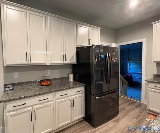 a kitchen with stainless steel appliances granite countertop a refrigerator and a stove