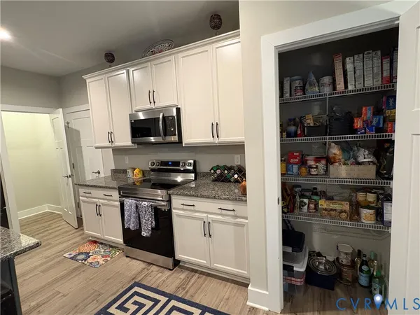 a kitchen with stainless steel appliances granite countertop a refrigerator stove and sink