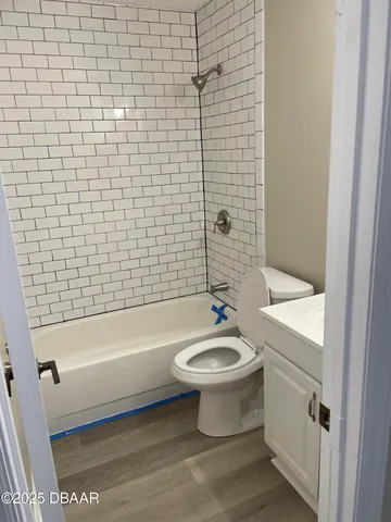 a bathroom with a sink a toilet and bathtub