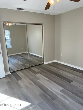 an empty room with fan and entrance