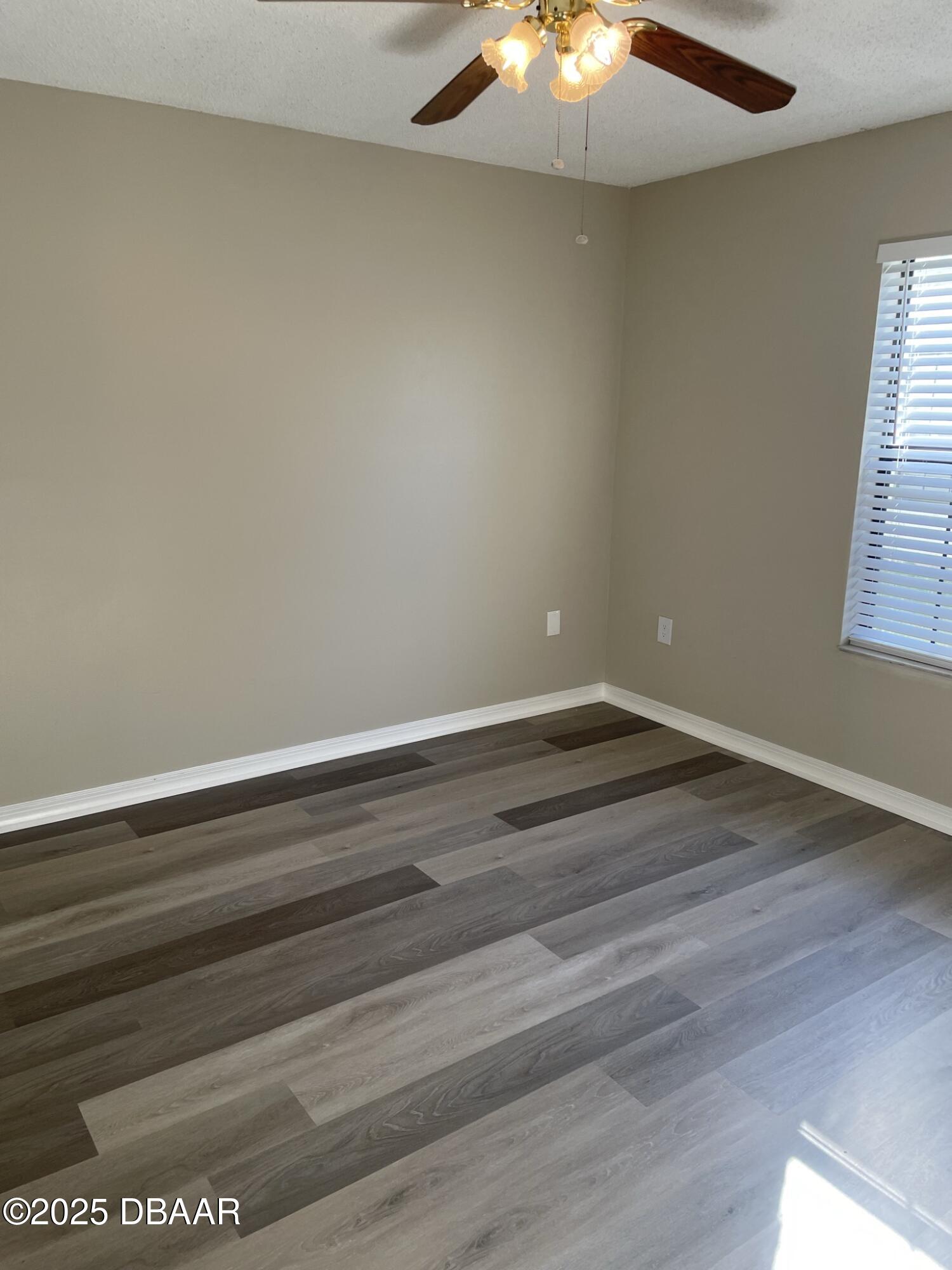 840 Center Avenue, Unit 75 Holly Hill, FL 32117 - Photo 15 of 17 a view of room with window and hardwood floor
