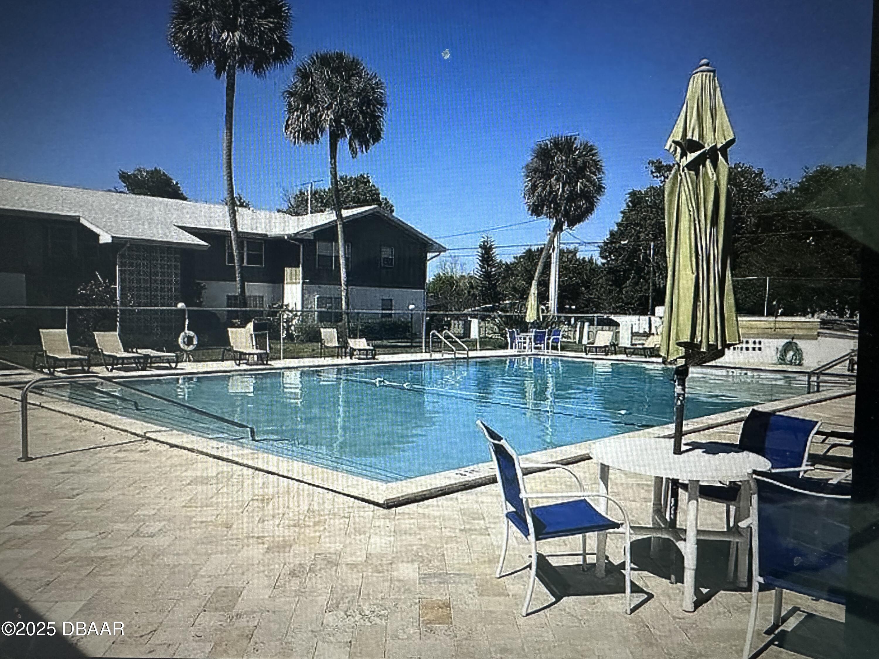 840 Center Avenue, Unit 75 Holly Hill, FL 32117 - Photo 2 of 17 a view of a swimming pool with a patio