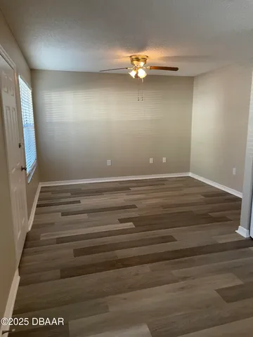 a view of room with stairs and wooden floor
