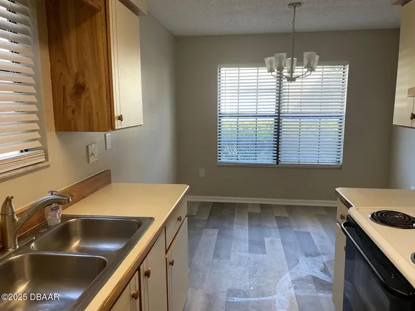 a kitchen that has a sink and a stove