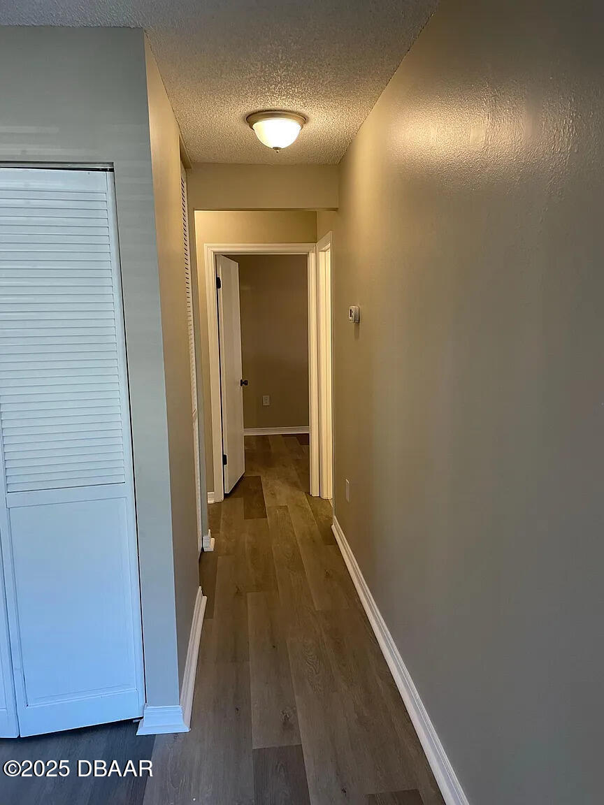 840 Center Avenue, Unit 75 Holly Hill, FL 32117 - Photo 9 of 17 a view of a hallway with wooden floor
