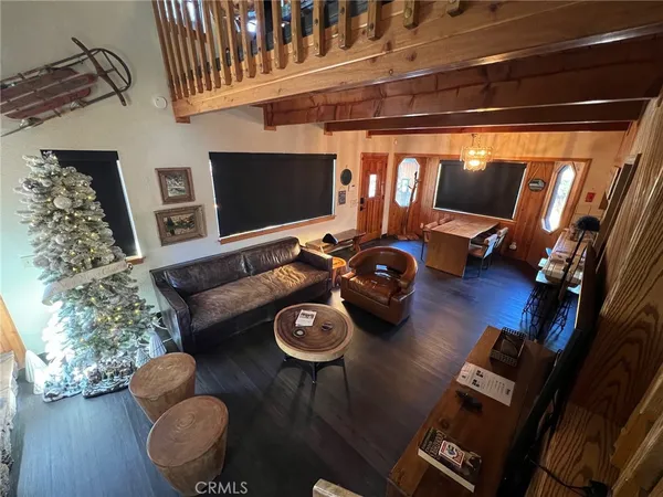 a view of a livingroom with furniture and a flat screen tv