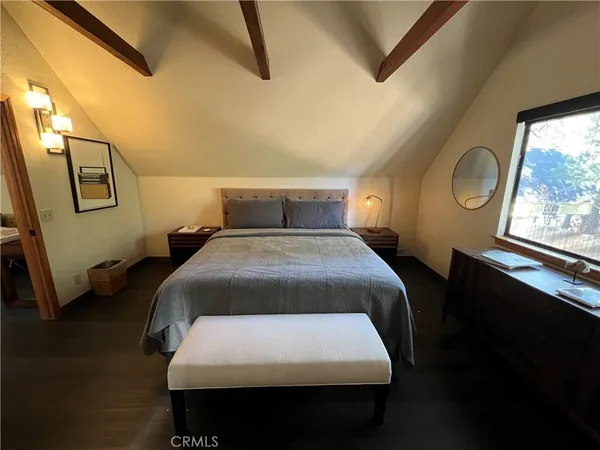 a bed sitting in a bedroom next to a window