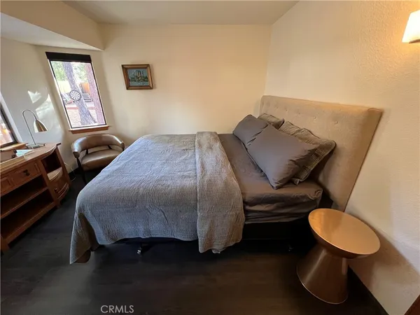 a bedroom with a bed flowerpot and window