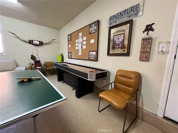 a living room with furniture and a air conditioner vent