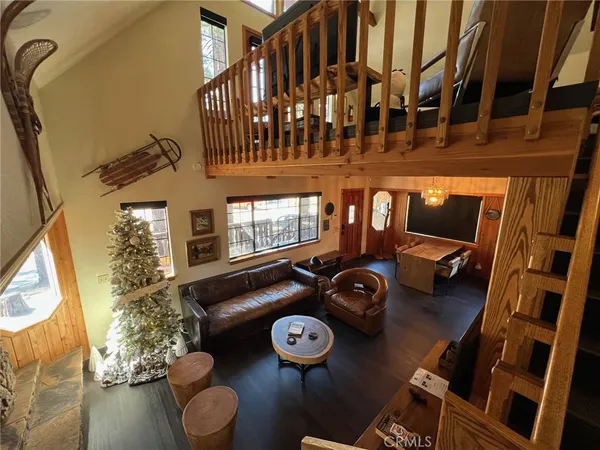 a view of a livingroom with furniture and a floor to ceiling window