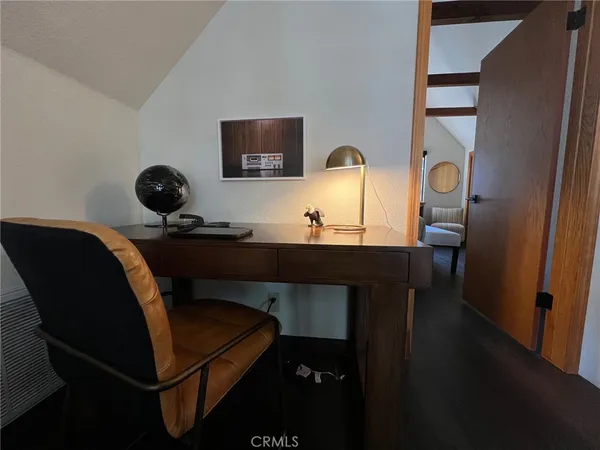 a work room with furniture and a wooden floor
