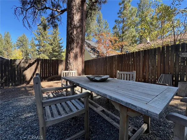 a view of a porch with wooden floor and outdoor seating