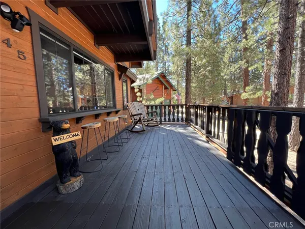 a view of balcony with two chairs and a barbeque