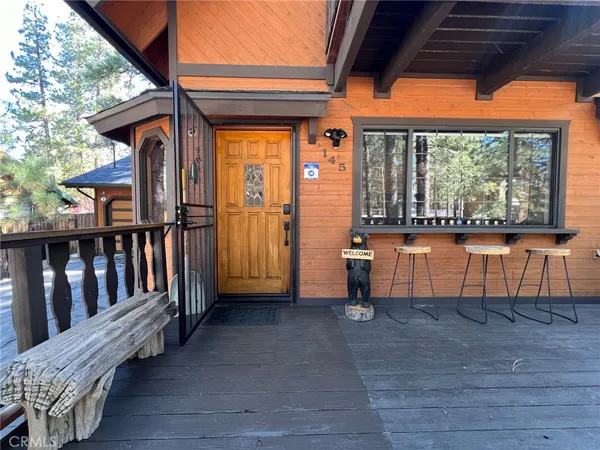 a backyard of a house with barbeque oven table and chairs