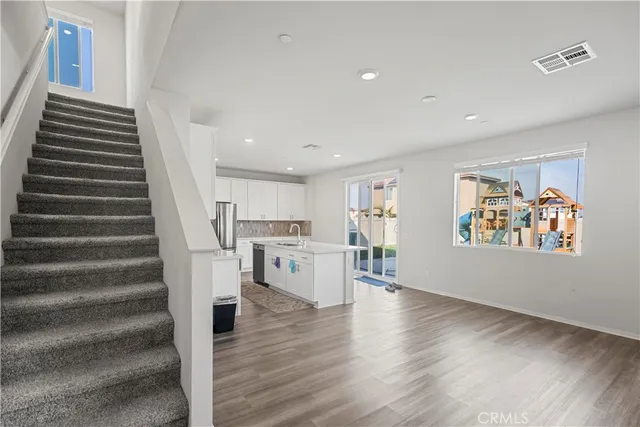 a large kitchen with stainless steel appliances granite countertop a sink and a stove