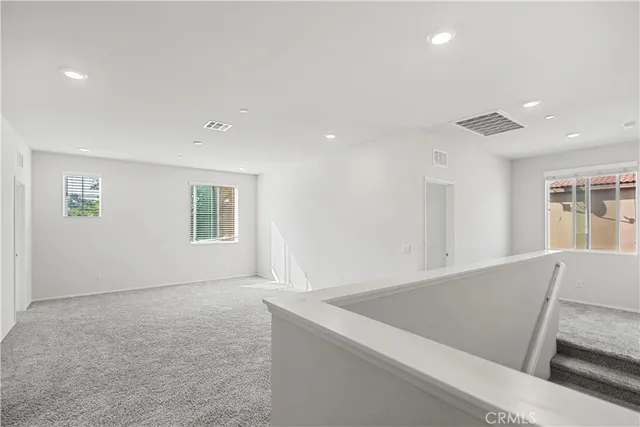 a bedroom with a bed and a large mirror