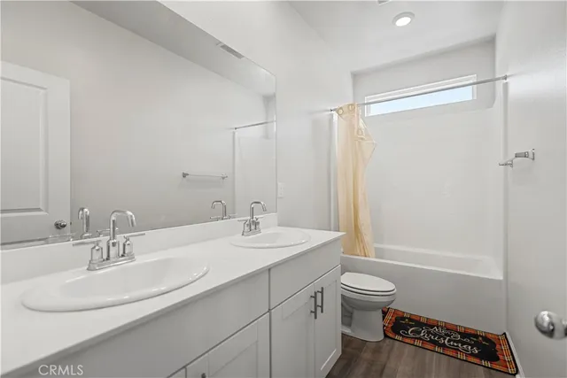 a view of a room with wooden floor and bench