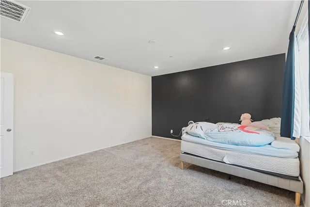 a view of a street with cars on both side of the road