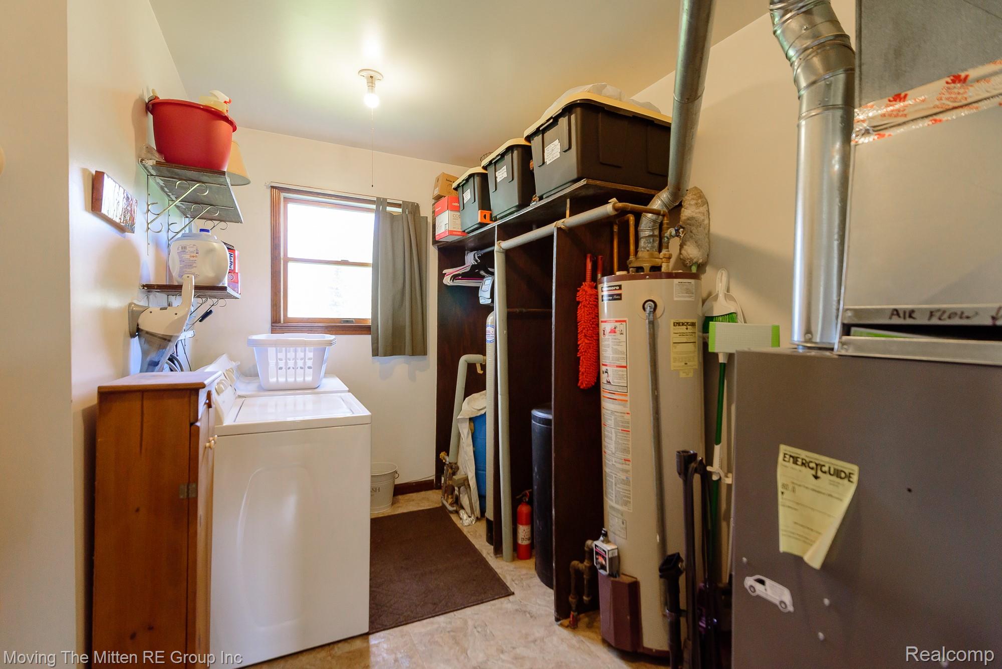9260 Pitman Road Ypsilanti, MI 48197 - Photo 28 of 45 Laundry room with heating unit, water heater, and washer and dryer