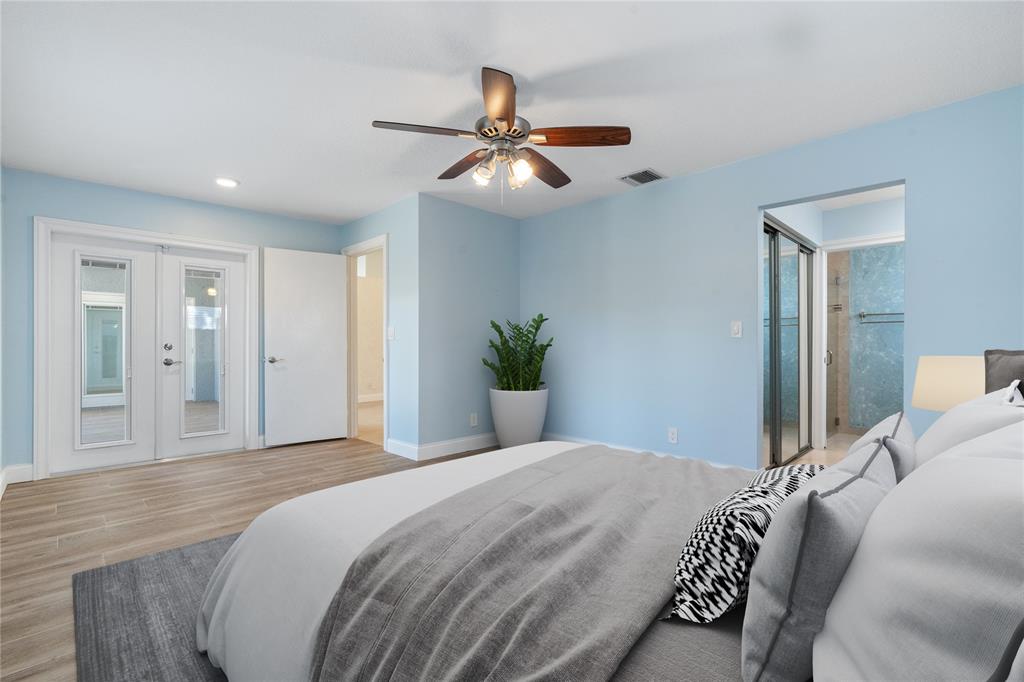 3240 Northwest 106th Avenue Sunrise, FL 33351 - Photo 11 of 21 a bedroom with a large bed and a chandelier